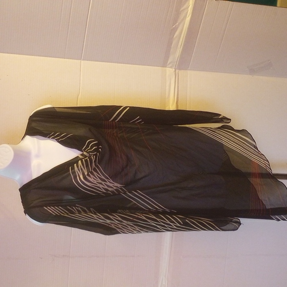 This is a black with red and white line print blouse by Caren Sport